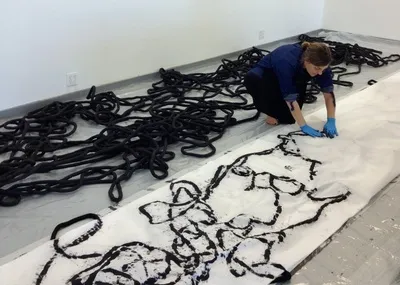 Heather Watkins, working on Score (2014), the large-scale sculptural wall drawing installed in the north atrium of Lincoln Performance Hall, and related scroll drawings from her series Transcripts and Readings (2013). Heather Watkins, working on Score (2014), the large-scale sculptural wall drawing installed in the north atrium of Lincoln Performance Hall, and related scroll drawings from her series Transcripts and Readings (2013).
