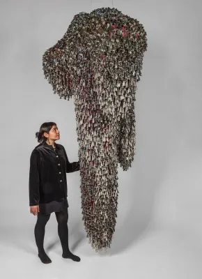 Marie Watt, Sky Dances Light: Forest V 2023, 120×58×39 in. Jingles, twill tape, mesh Collection of Yale University Art Gallery, New Haven, CT Made in collaboration with Portland Garment Factory, Portland, OR Photograph by Kevin McConnell Marie Watt, Sky Dances Light: Forest V 2023, 120×58×39 in. Jingles, twill tape, mesh Collection of Yale University Art Gallery, New Haven, CT Made in collaboration with Portland Garment Factory, Portland, OR Photograph by Kevin McConnell